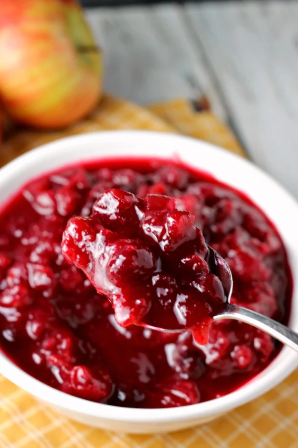 Apple Cranberry Sauce | by Renee's Kitchen Adventures on a spoon in a white bowl