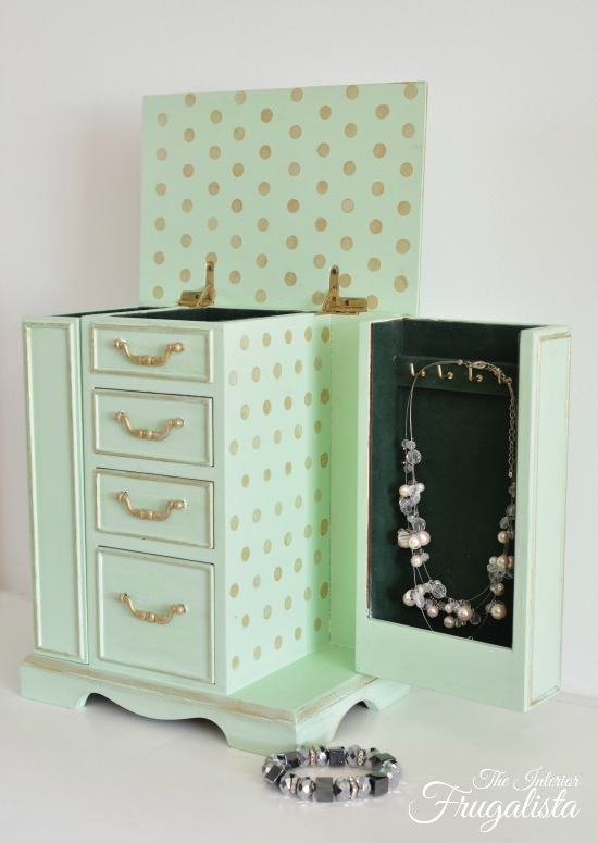 An upcycled thrift store vintage armoire jewelry box painted a pretty mint custom chalk-style paint color with gold accents and fun polka dots inside.