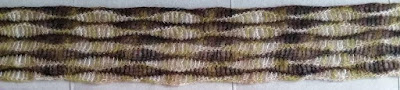 Central section of the Woodland scarf. Laid horizontally, wavy stripes along the length of the scarf alternate in colours of green/beige and browns,