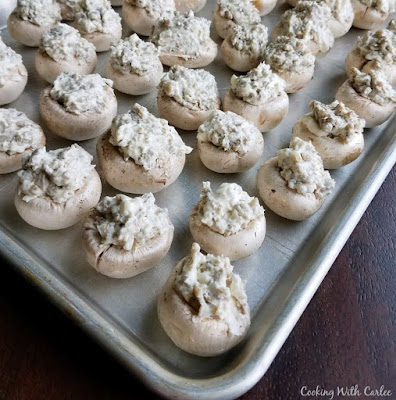 sheet pan with stuffed mushrooms ready to bake