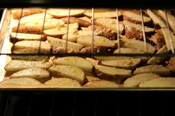 Crispy Oven-Baked Garlic Parmesan Potato Wedges | by Renee's Kitchen Adventures - A healthy side dish with a secret for perfectly crispy oven potatoes!  Crunchy on the outside and fluffy on the inside! 