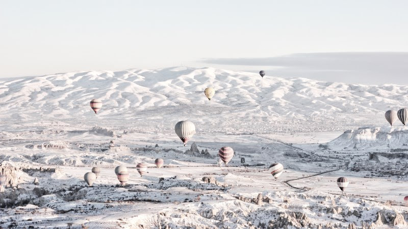 Hot Air Balloons over the Snowy Landscape