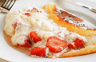 Soufflé omelette filled with fruit and cream. An elegant dessert for two.