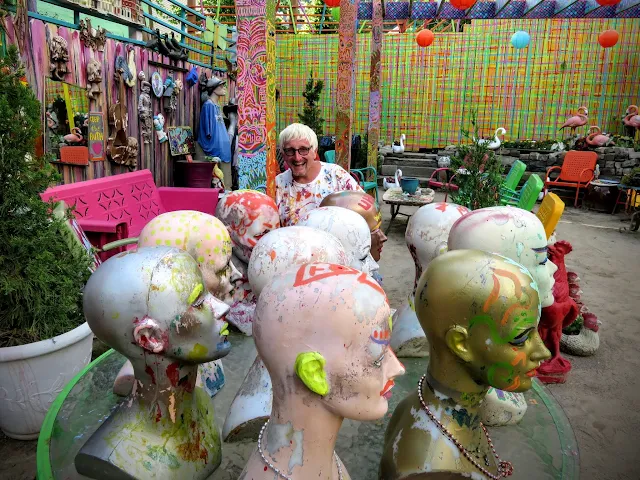 Randy and bald wig stands at Randyland in the Mexican War Streets neighborhood of Pittsburgh