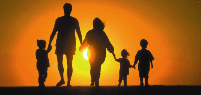 família caminhando ao por do sol