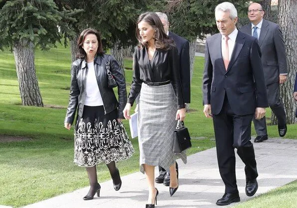 Queen Letizia wore a pointed-check wool skirt by Massimo Dutti and Prada leather pumps and she carried Hugo Boss leather bag