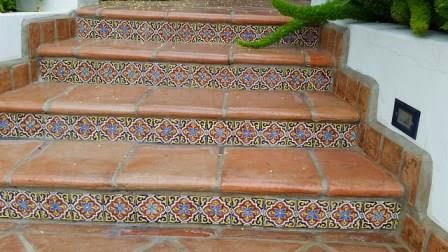 Saltillo tile walkway features hand-painted ceramic tiles on the risers.