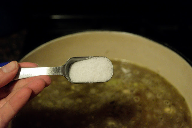 Salt being added to the pot.