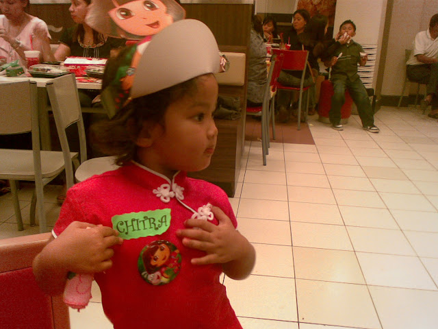 Kecil looking on in her Dora hat