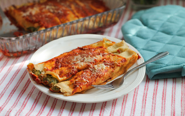 Food Lust People Love: Use your favorite greens to make Greens and Pea Manicotti, a lovely savory vegetarian main course of crepes filled with peas, goat cheese, ricotta and, of course, greens, covered in a fragrant tomato sauce.