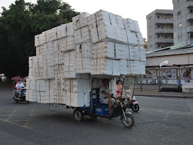 motor tricycle cart carrying many styrofoam containers in Zhongshan, China