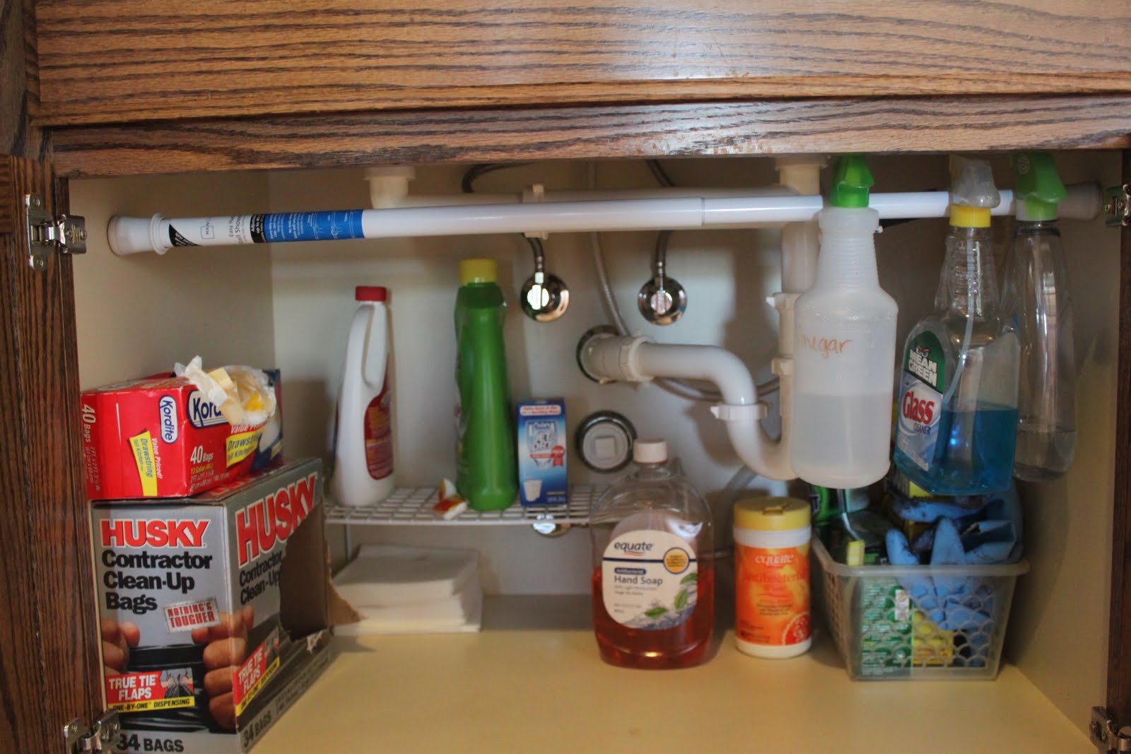 time-and-space-designs-tension-rod-to-organize-cleaning-supplies