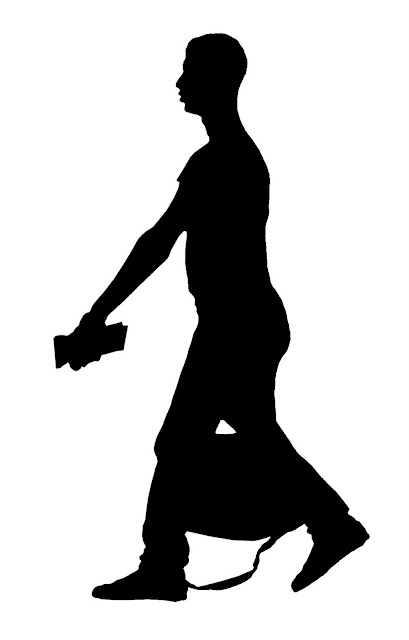 silhouette of young man with bag at airport
