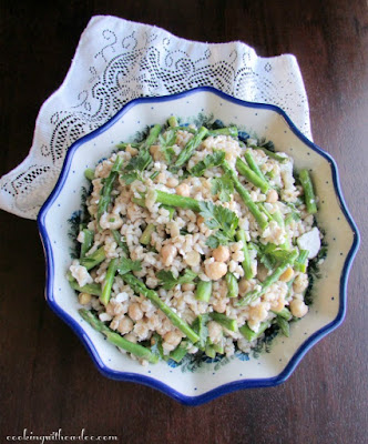This asparagus, barley and chickpea salad is the perfect hearty side dish. It is bright, fresh and delicious. The leftovers make a fabulous lunch as well! polish pottery bowl filled with abc salad