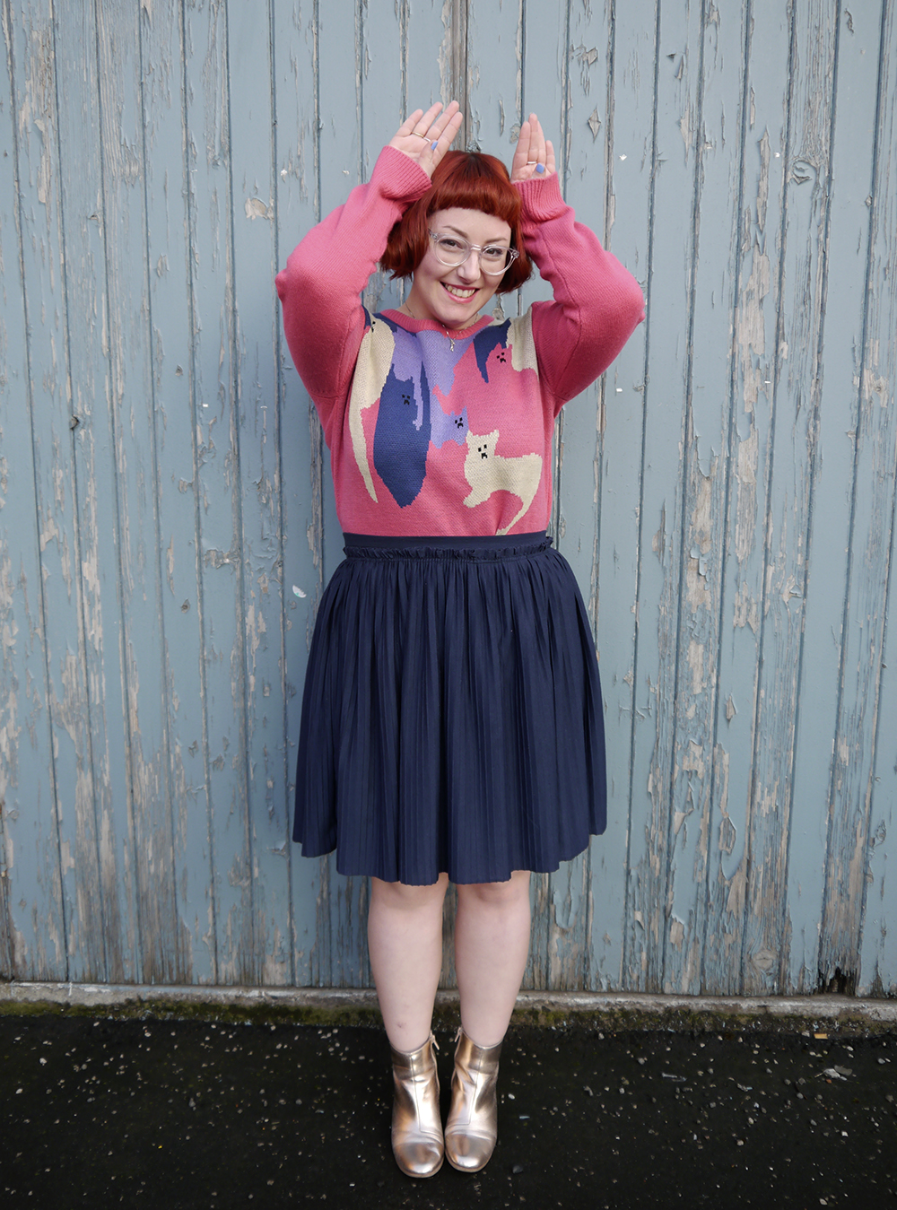 Styled by Helen, Scottish blogger, Dundee blogger, Scottish fashion blogger, quirky style, Scottish street style, cute style, cat clothing, dressing to a theme, cat themed clothing, cat jumper, colourful outfit, colourful street style, La La Land, colourful cat jumper, pink jumper, pink and blue outfit, red head, ginger bob, clear glasses, Iolla glasses, cat necklace, silver cat necklace, gold boots, cat pose, cute cat outfit