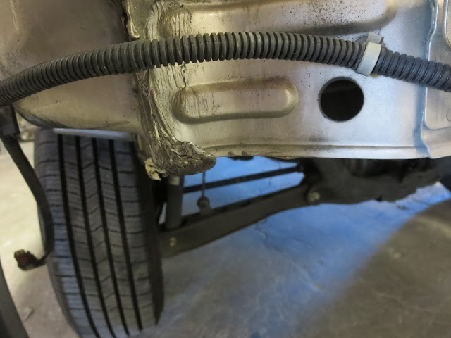 Bent, cracked panel found under bumper during auto body repairs on Honda CR-V