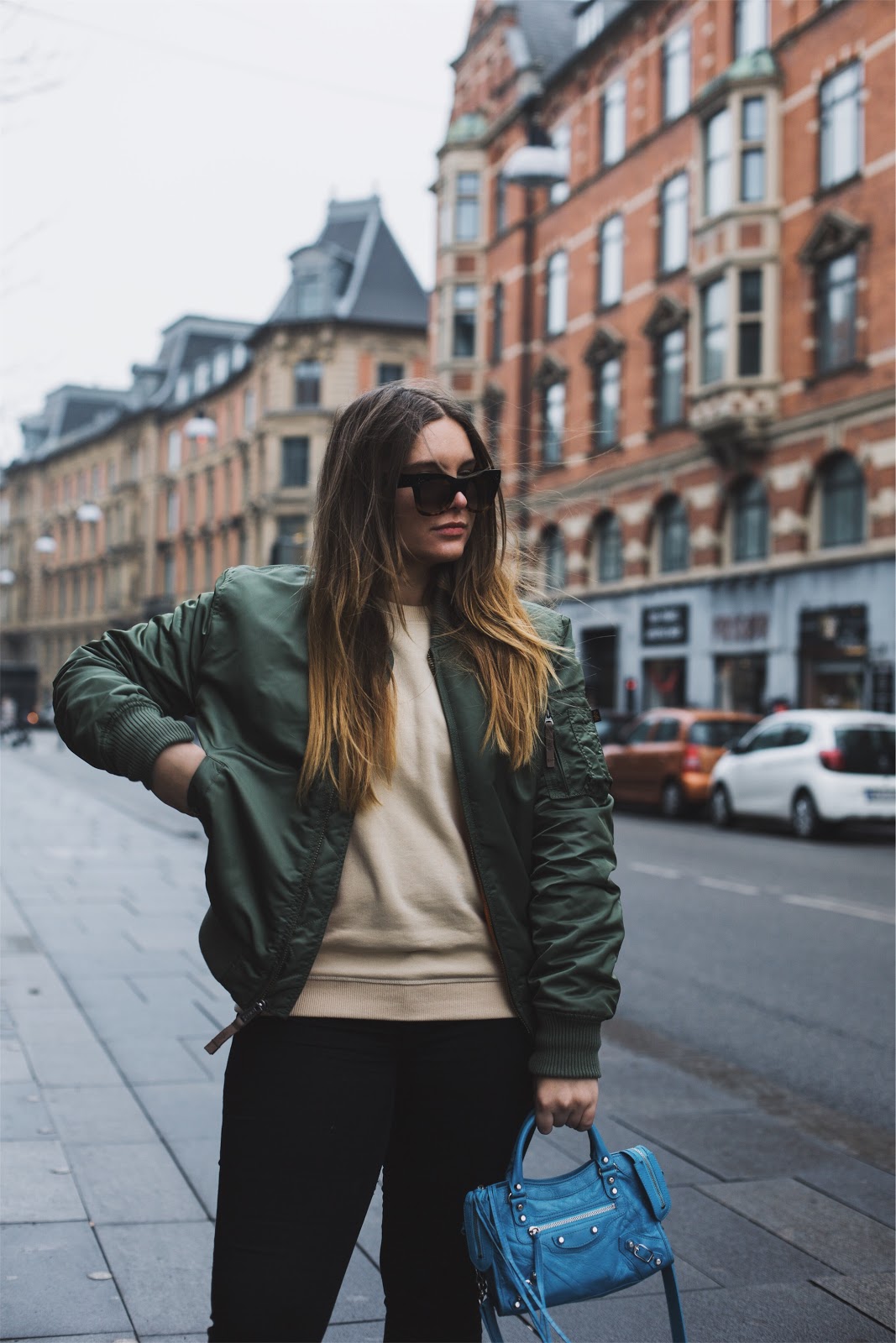 RUNNING ERRANDS IN COPENHAGEN fashion blogger dominique candido wearing alpha industries bomber balenciaga bag celine sunglasses and alexander mcqueen sneakers