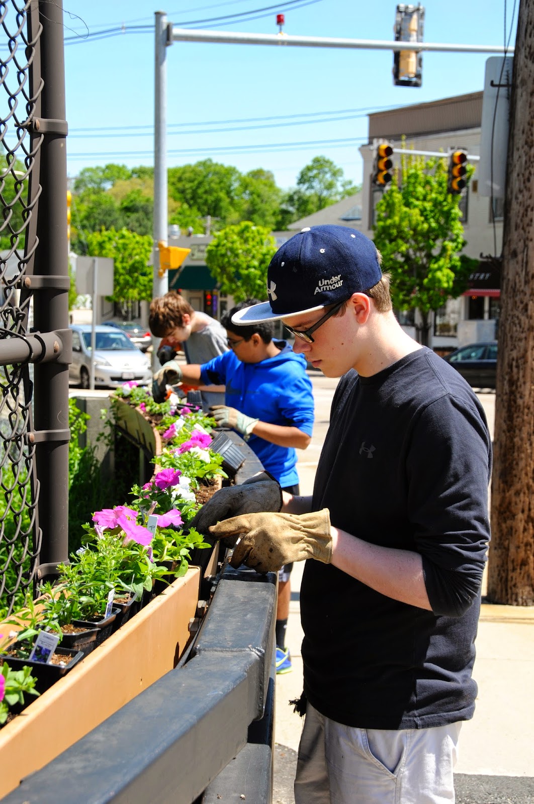 Volunteers plant flowers on the Main Street bridge last spring