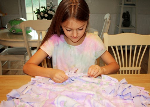 Tessa and I shared the work of knotting the fringe. She knotted about half the bed. In a troop setting, having the girls knot one of the four sides would likely be plenty. That was about the extent of Tessa's stamina, but I urged her on a bit beyond that.