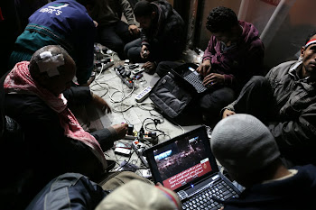 Anti-government bloggers work on their laptops from Tahrir Square. Despite government attempts to s