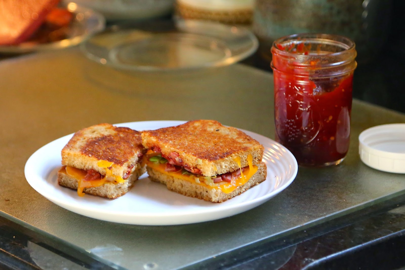 Sweet and salty, tangy and gooey, this grilled cheese sandwich with country ham, leeks, and tomato jam hits all the right notes.