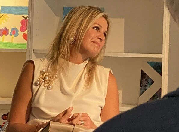 Queen Maxima wore Zara Sleeveless high-neck shirt. Maxima wore a sleeveless top by Zara. pearl earring and pearl brooch