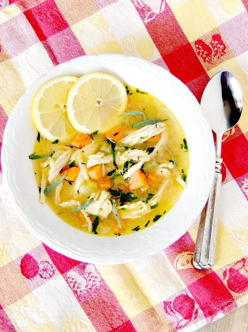 Lemon Chicken Noodle Soup Lemon Chicken Noodle Soup in a white bowl with a silver spoon on a red and yellow plaid tablecloth