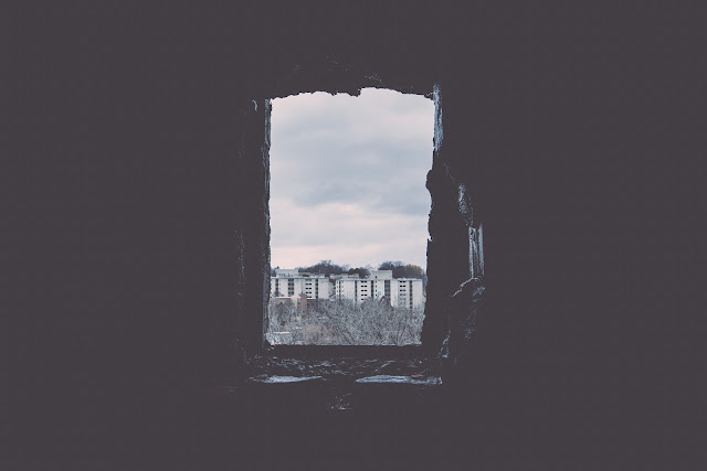 Dark Opened Framed Window View of Buildings