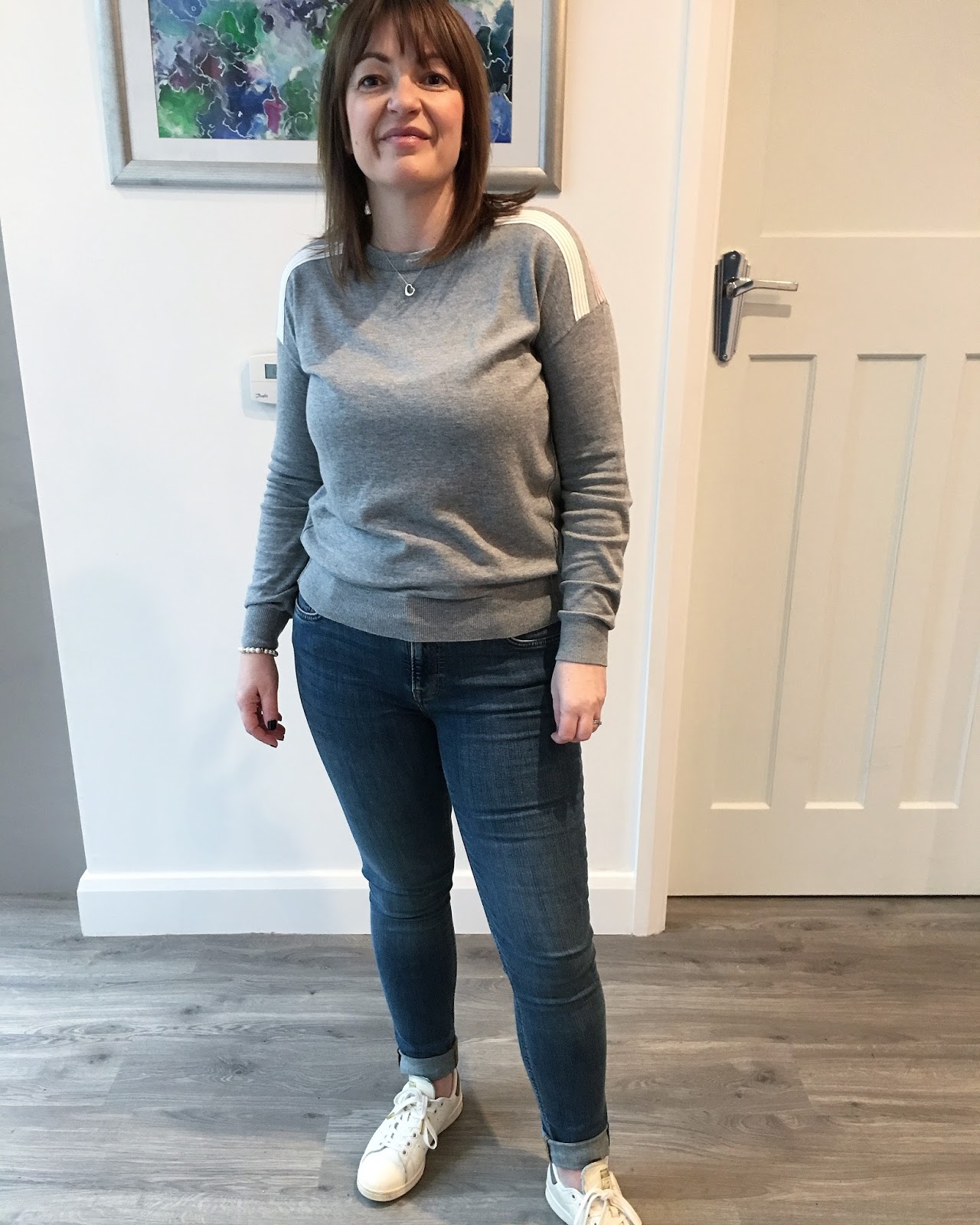 grey jumper and jeans