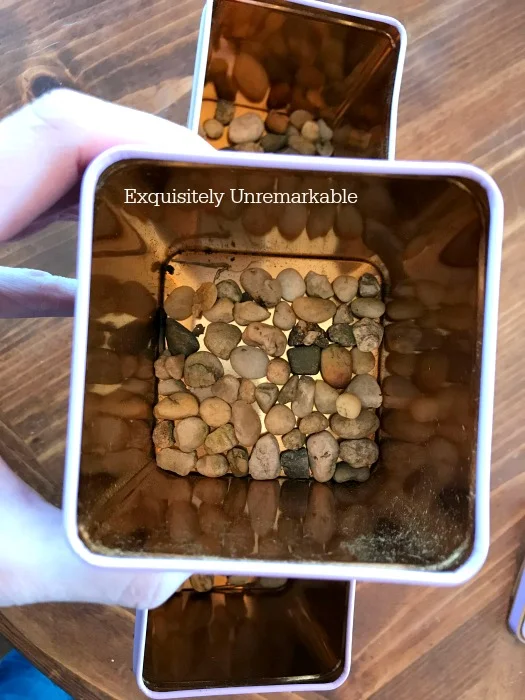 Adding Pebbles To Tins For Drainage