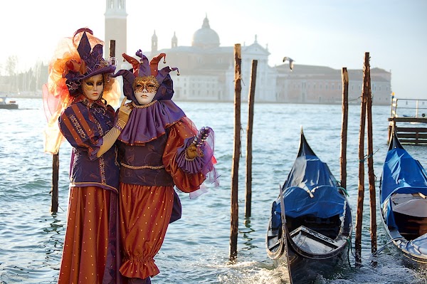 two people in costumes in front of grand canal during Venice Carnival