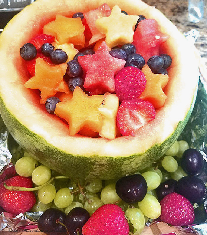 Watermelon carved out and filled with various cookie cutter shaped images for a festive 4th of July Fruit Bowl