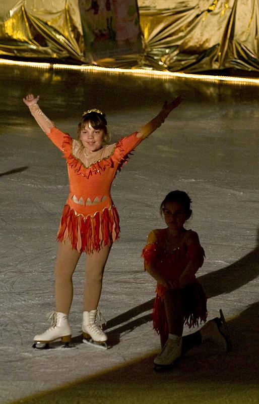 Young girls in costume at a figure skating event.