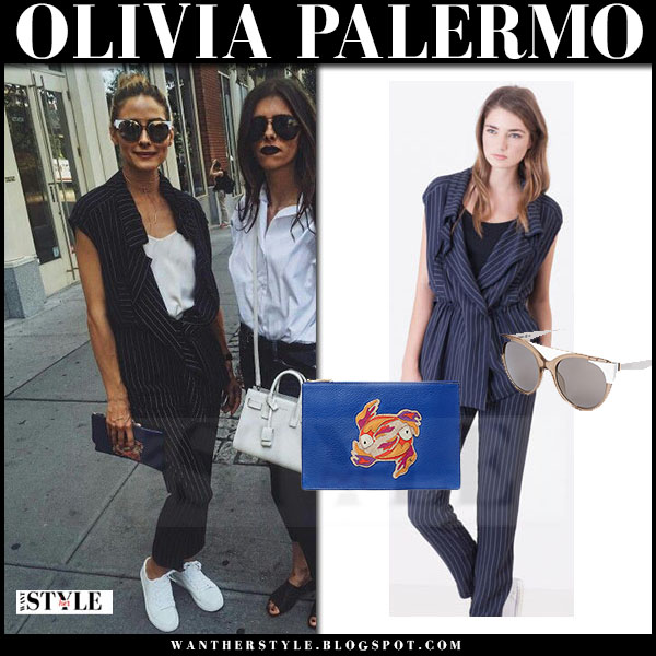 Olivia Palermo in navy pinstripe top and trousers with blue clutch and
