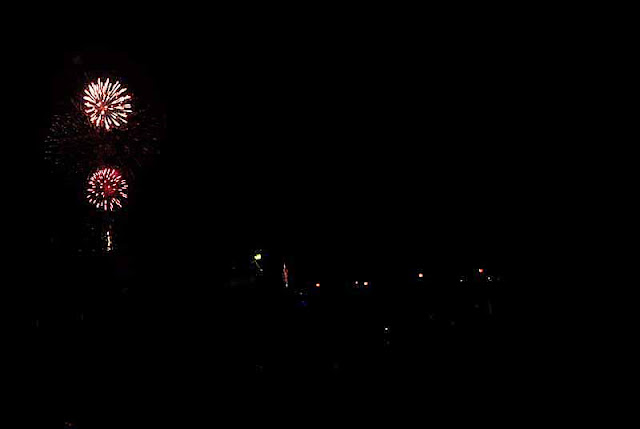 Fireworks over festival grounds at night