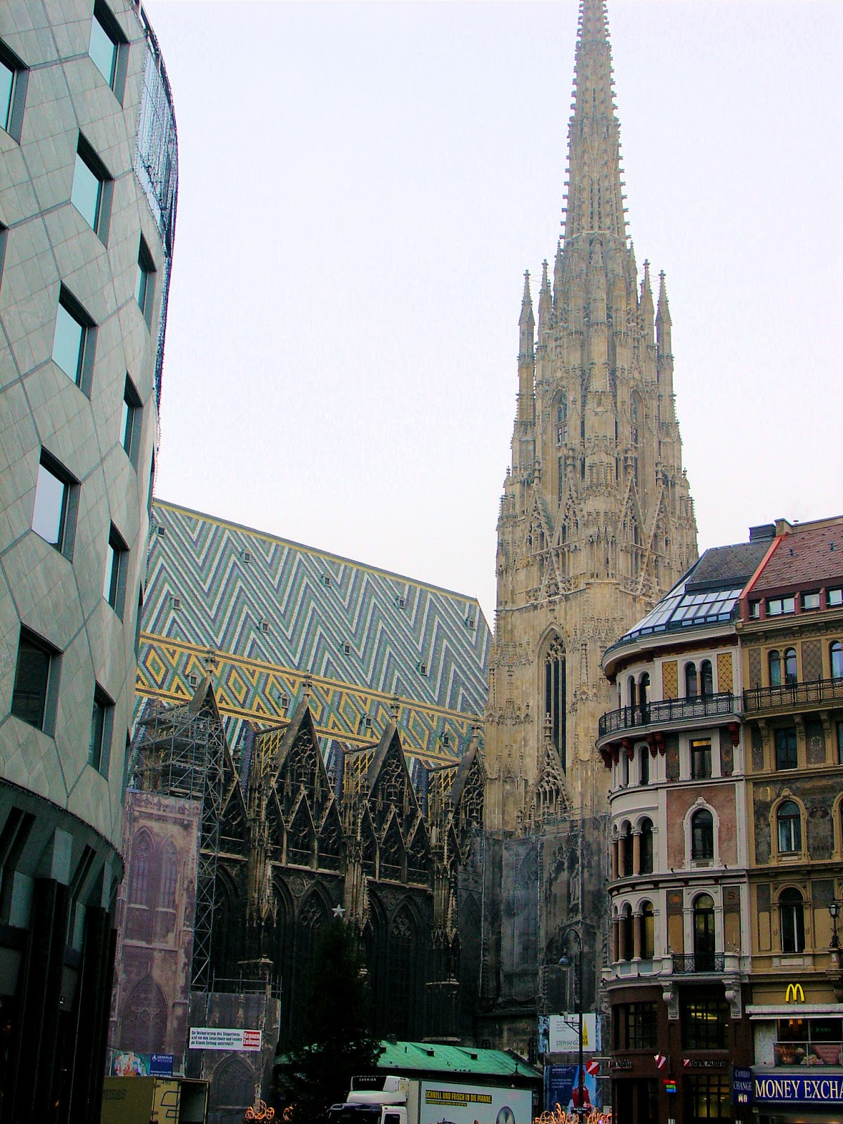 The Haas Haus at the left has become a controversy in the city of Vienna due to its modern architectural style juxtaposed with Saint Stephan's in the background. Look deeper, and more contrast in the geometric patterns on the roof.