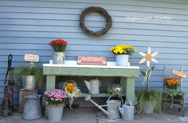 Fall Potting Bench with Mums, Ivies, Ponytail Grass, and Galvanized Cans and Buckets