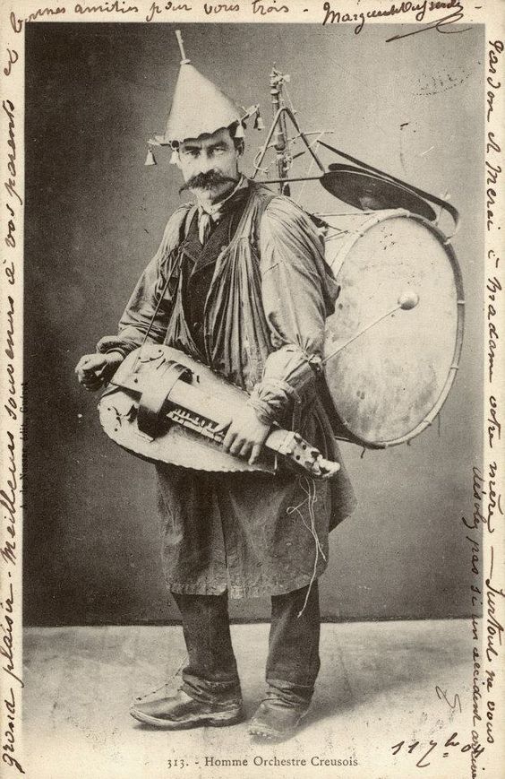 Vintage photo. One man band. Dapper gent covered in musical accoutrements jingle hat and a hand cranked Hudy-Gurdy. Jingles and other stories of The American Dream. marchmaton.com Vintage photo. One man band. Dapper gent covered in musical accoutrements jingle hat and a hand cranked Hudy-Gurdy. Jingles and other stories of The American Dream. marchmaton.com