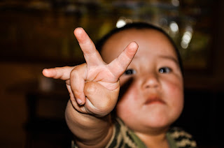 toddler holding up 3 fingers