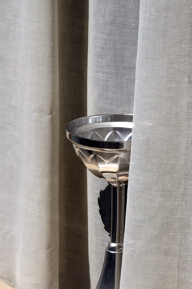silver cup in window