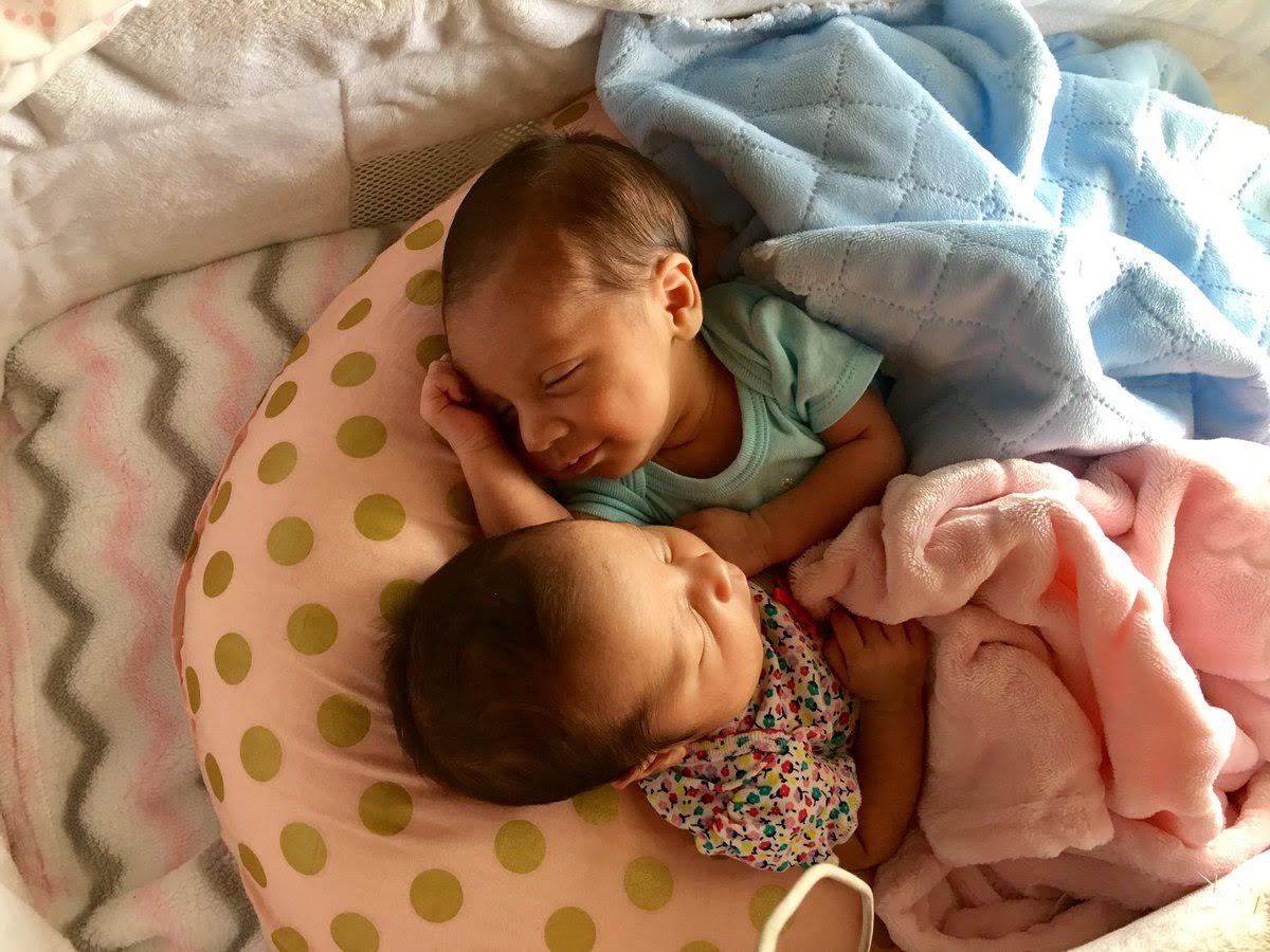 Adorable photos of infant twins embracing while sleeping go viral