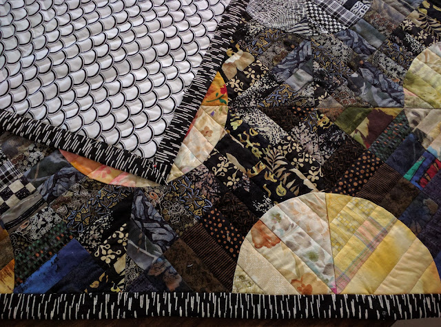 Marimekko fabric used to bind Strips 'n Curves quilt