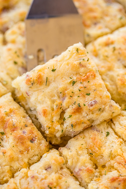Cracked Out Butter Dips - biscuits loaded with cheddar, bacon and ranch! Only 8 simple ingredients! You probably have them in your pantry right now! No-kneading at all! Just mix dough together and pat down in pan. Ready in under 15 minutes! Everyone RAVES about these easy biscuits!! Great with dinner or for breakfast. YUM! #biscuits #bacon #breadrecipes Cracked Out Butter Dips - biscuits loaded with cheddar, bacon and ranch! Only 8 simple ingredients! You probably have them in your pantry right now! No-kneading at all! Just mix dough together and pat down in pan. Ready in under 15 minutes! Everyone RAVES about these easy biscuits!! Great with dinner or for breakfast. YUM! #biscuits #bacon #breadrecipes