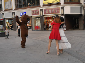 person in bear suit handing out flyers