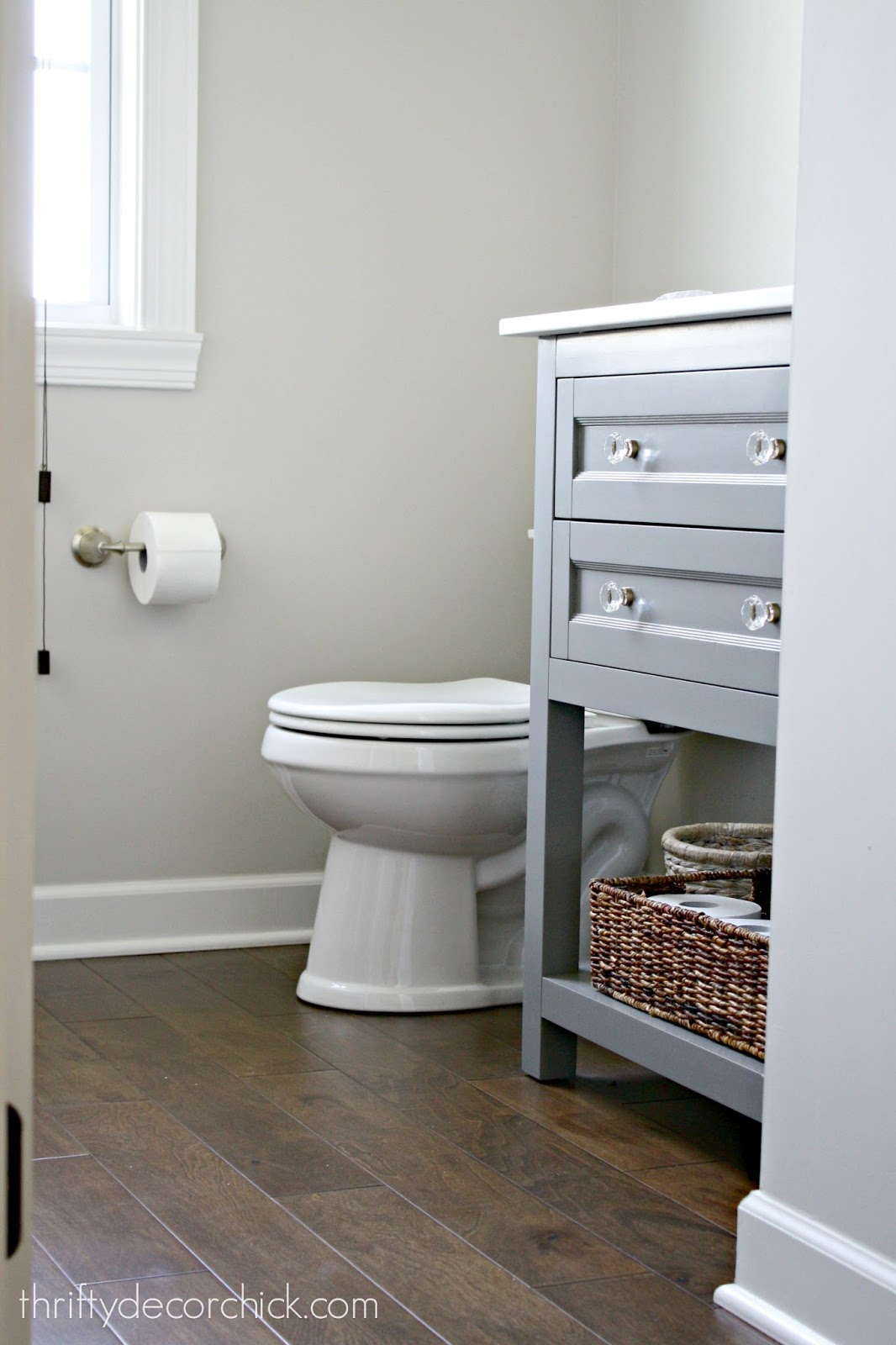 Dark wood floors, gray vanity bathroom