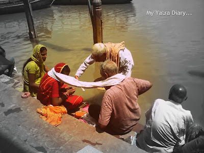 Believers doing shraddha at the Yamuna River Ghat, Mathura