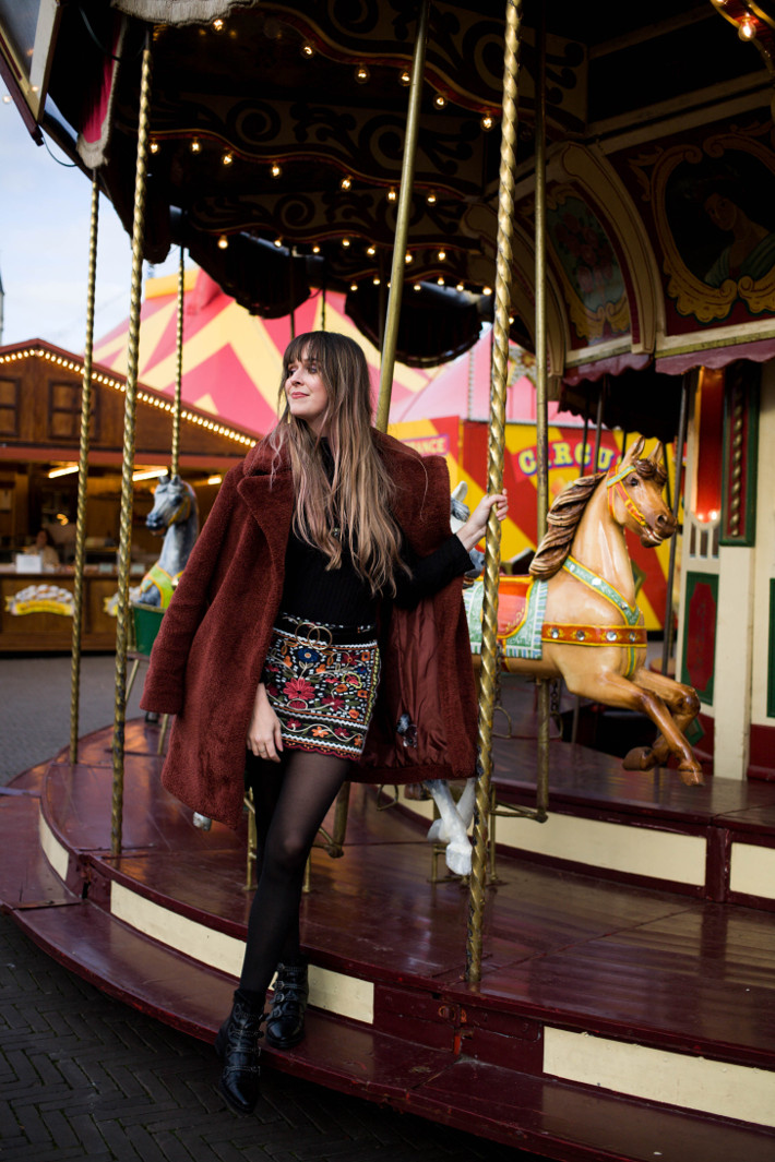 rust coloured teddy coat, embroidered skirt, buckle boots