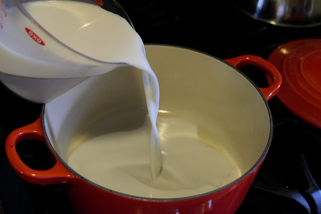 The almond milk being poured into the sauce pan.                                                                                 