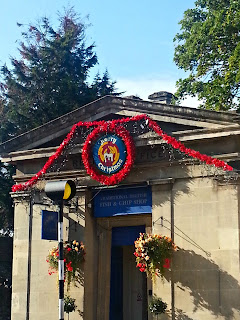 Building Decorated for Christmas Building with Christmas decorations, and flowering hanging baskets.