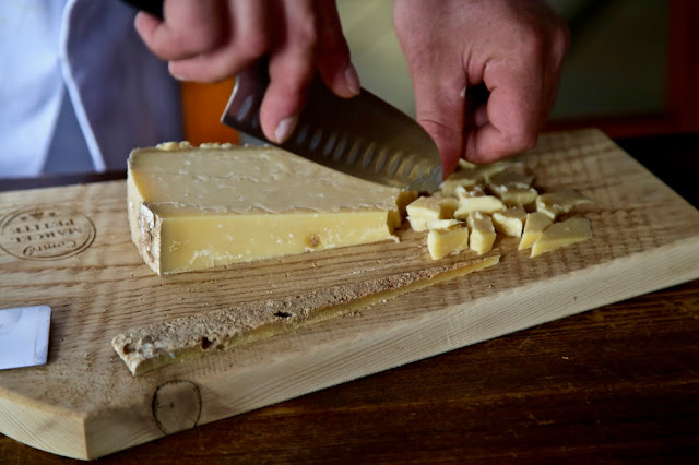 Chipping a piece of mature 3 year old Comté, Fort de Saint-Antoine, Franche-Comté
